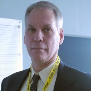 Clean-shaven man with short graying hair